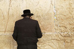 a-jewish-man-wearing-orthodox-clothing-prays-by-the-western-wall-wailing-wall-jerusalem-israel...jpg